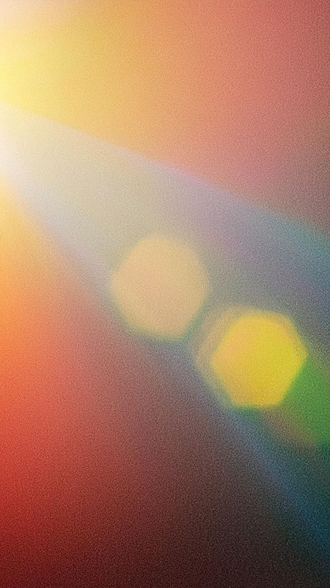Soft grainy spectrum haze with golden bokeh hexagons