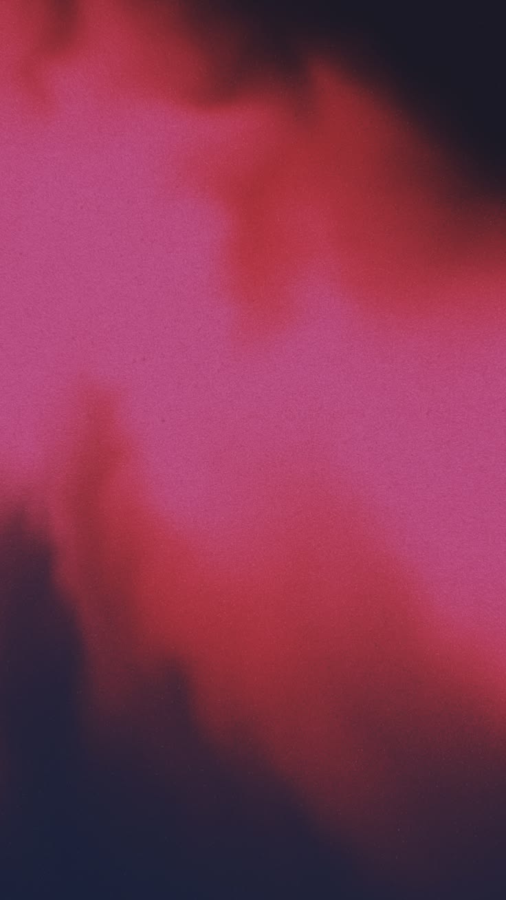 Grainy cloud of hot pink and crimson bleeding across a dark ground