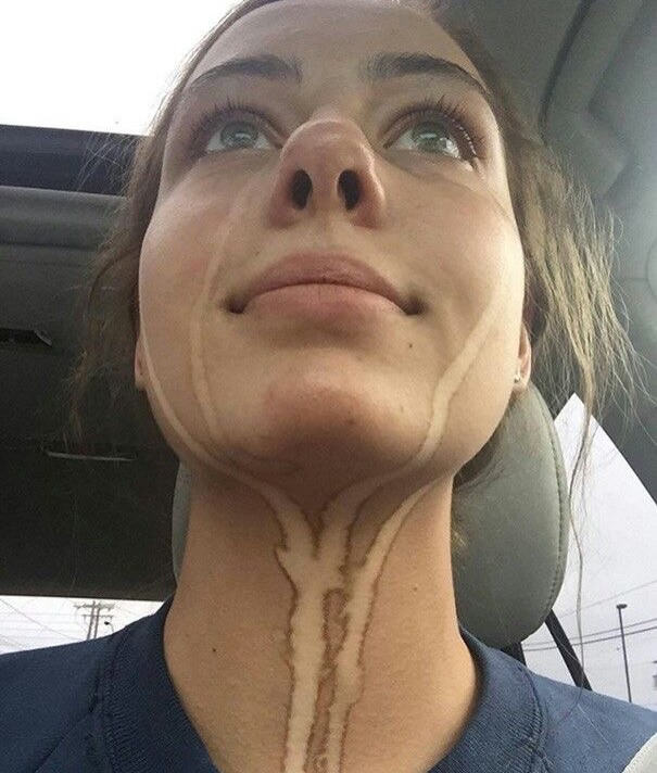Face tilted up, dried tear tracks running down the cheeks and neck