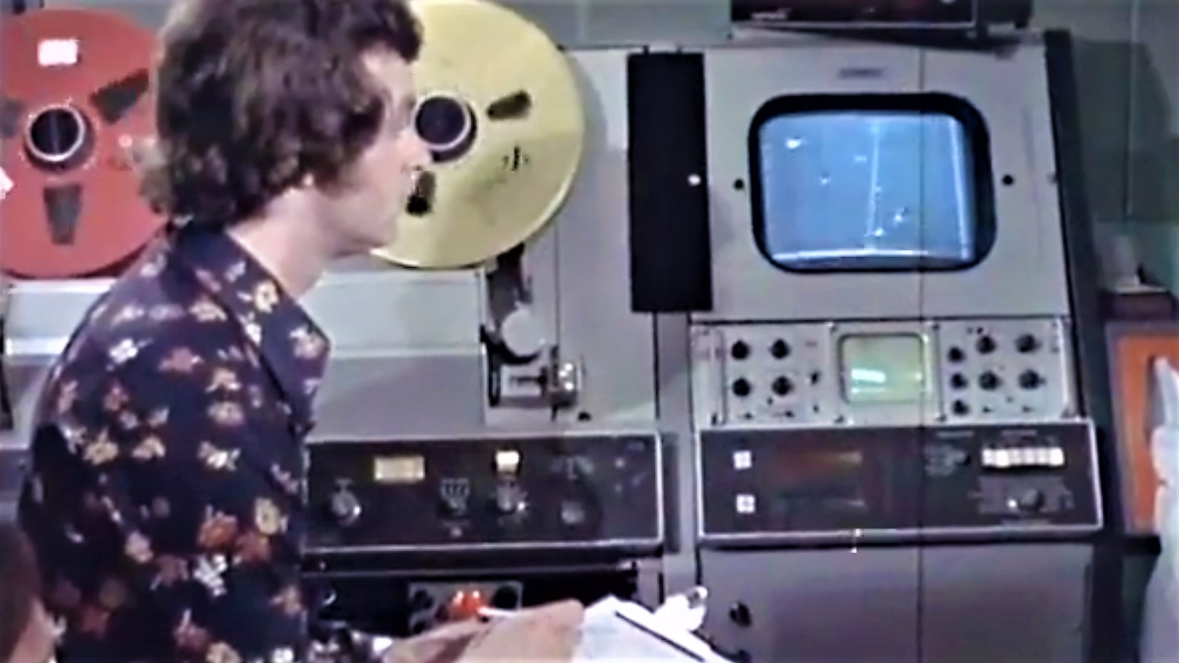 Operator working VHS tape machine in a colour broadcast studio