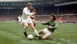 Match action slide tackle in early colour footage