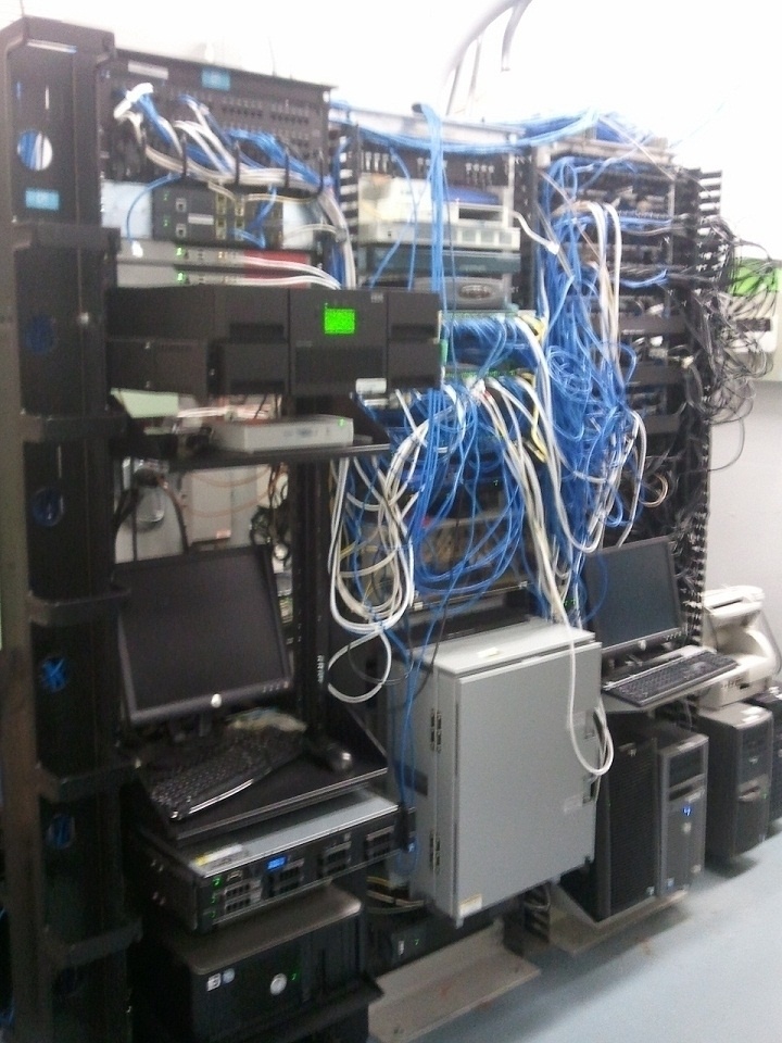 Network rack overwhelmed with blue ethernet cables