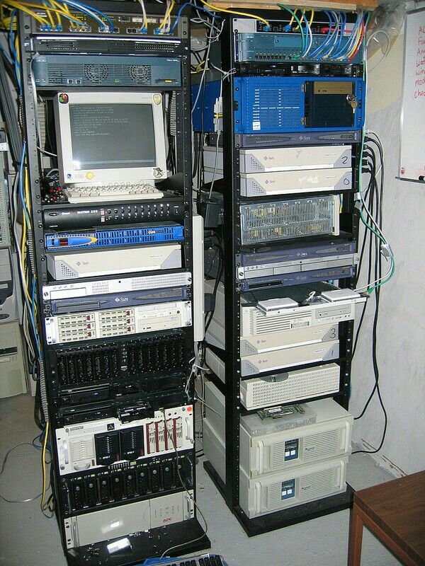 Two server racks loaded with early 2000s hardware and cabling